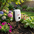 Ultrasonic Squirrel Repeller staked in a backyard garden