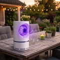 UV Light Insect Trap glowing on a patio table